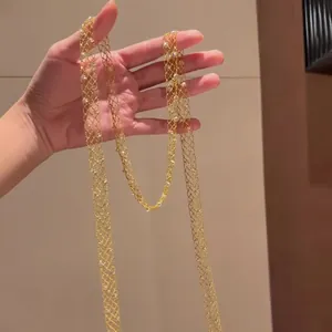 Detailed macro view showing the intricate golden hollow mesh design of this long necklace.