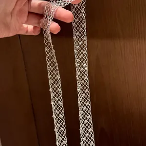 Close-up of silver mesh long necklace with clear glass beads detailing