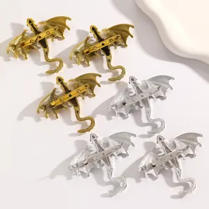 Detailed back view of vintage enamel dragon brooches showing secure pin mechanisms.