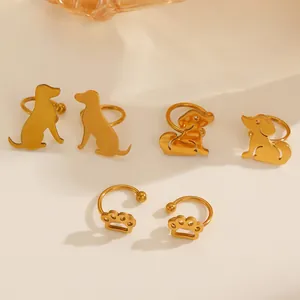 Detailed view of gold dog and paw print ear cuffs with smooth metallic finish