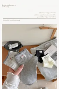 Close-up of Korean style socks with ruffled contrast cuffs and cute dog cloth label