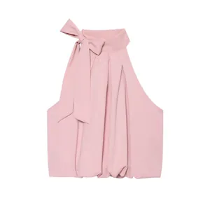 Elegant pink halter neck sleeveless top featuring a large bow tie and pleated fabric