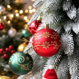 Elegant red hand-painted Christmas ball ornament with gold glitter floral patterns on tree