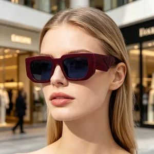 Close-up of model wearing stylish burgundy square sunglasses with textured wide temples