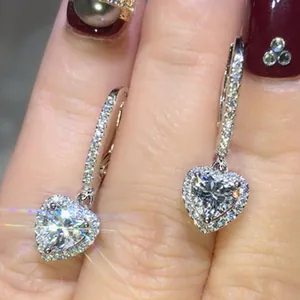Detailed view of elegant silver-toned heart-shaped zircon drop earrings with sparkle