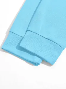 Close-up of light blue mesh fabric cuff detail on men's long sleeve Polo shirt.