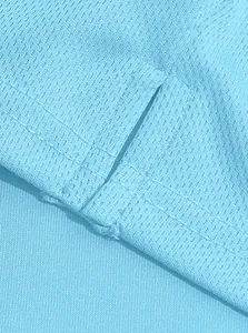 Close-up of side slit and breathable mesh fabric on light blue long sleeve Polo shirt