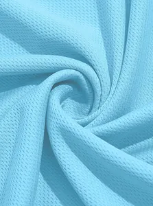 Close-up of breathable light blue mesh fabric texture for a men's sports Polo shirt