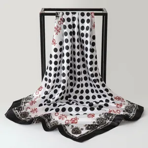 Macro detail of retro paisley and polka dot printed satin scarf draped on frame