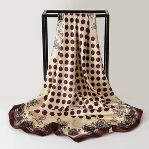 Detailed macro view of vintage paisley and polka dot printed satin square scarf for women