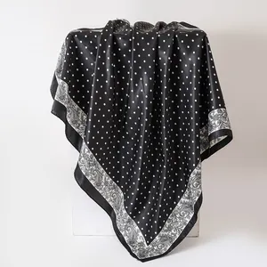 Elegant black satin scarf with white polka dots and retro paisley border detail
