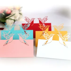 Elegant laser-cut bird design wedding place cards in multiple colors for guest seating