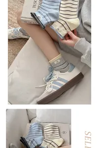 Close-up of soft combed cotton crew socks with colorful stripes and egg label detail