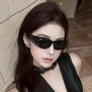 Detailed view of an Asian model wearing trendy black sports sunglasses for cycling.