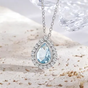 Detailed macro view of s925 silver teardrop pendant necklace with blue crystal