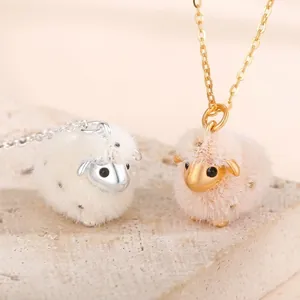 Close-up detail of cute plush sheep pendant necklaces in gold and silver finishes