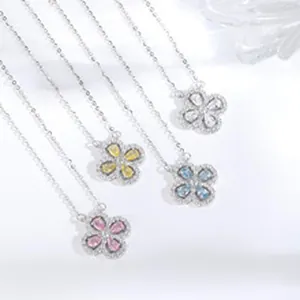 Close-up of four-leaf clover necklaces in pink blue and yellow silver gemstone details