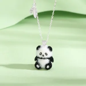 Close-up view of a cute fuzzy panda pendant necklace with an elegant silver chain