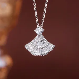 Macro view of elegant fan-shaped silver pendant encrusted with glittering crystals.