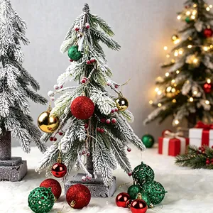 Festive Christmas ornament set with glitter and hollow baubles displayed on snowy tree