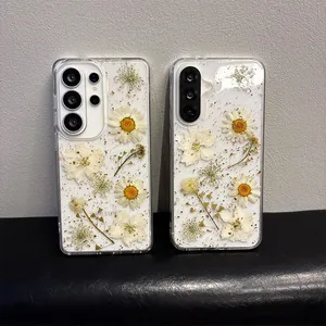 Close-up of clear phone case for Samsung featuring real pressed daisies and gold foil