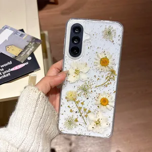 Detail view of Samsung phone case with real pressed daisies and gold foil flakes