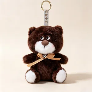 Adorable brown plush bear keychain pendant featuring a golden bow tie and heart charm