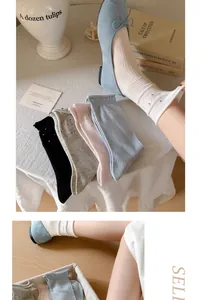 Detailweergave van dunne katoenen rufflesokken met stippen in diverse pastelkleuren