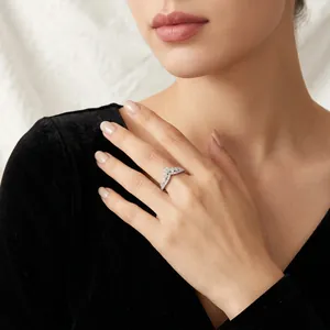 Elegant V-shaped S925 silver Moissanite ring with shimmering stones on female model hand