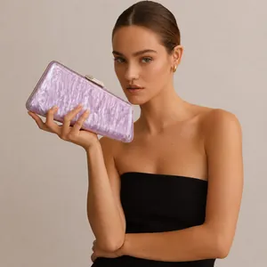 Elegant model holding a purple marble texture acrylic clutch bag with silver clasp