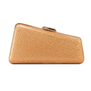 Close-up detail of a geometric gold glitter evening clutch with a premium metal clasp