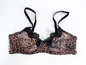 Detail view of a sexy leopard print lace bra featuring sheer mesh and black floral trim