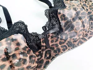 Close-up detail of leopard print lace mesh bra with bow and sheer texture