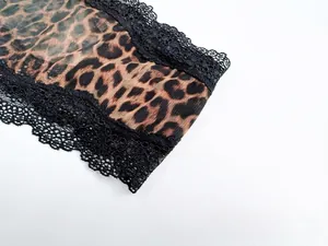 Macro detail showing leopard print mesh fabric and delicate black lace trim on sexy lingerie