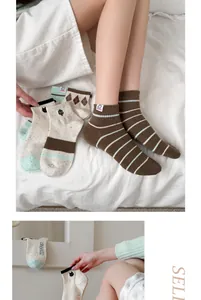 Detailed view of cute Japanese style cartoon striped cotton socks for women in soft tones