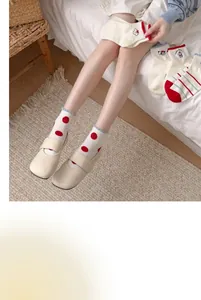 Cute cotton crew socks with red polka dots and puppy designs shown in a lifestyle setting