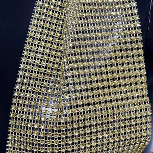 Detailed view of golden sparkling rhinestone mesh fabric for halter neck crop top