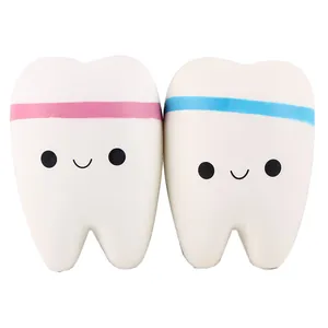 Detail view of two cute tooth-shaped slow rebound squishy toys with smiling faces