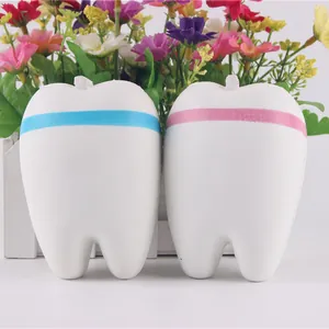 Detailed view of two white tooth-shaped slow rebound squishy stress relief toys