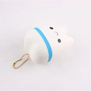 Close-up view of a white tooth-shaped slow rebound squishy toy with a cute smiley face