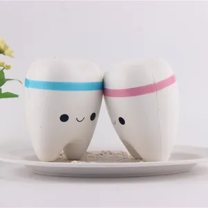 Detail shot of two cute smiling tooth-shaped PU squishy toys for stress relief