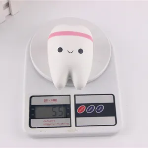 Slow rebound tooth squishy toy placed on a digital scale displaying a weight of 55g