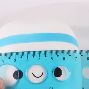 PU slow rebound tooth squishy toy being measured with a blue ruler for size reference