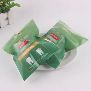 Detail view of two packaged green PU slow rebound tooth squishy stress relief toys.