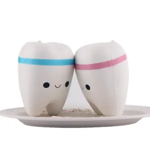 A pair of cute tooth-shaped PU slow-rebound squishy toys for stress relief and fun