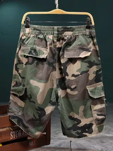 Detailed view of men's tactical camouflage cargo shorts with multi-pocket design
