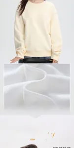 Close-up detail showing the soft white fleece lining of a beige crewneck sweatshirt.