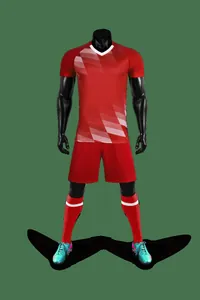 Red soccer jersey set with gradient geometric pattern on black mannequin
