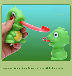 Close-up detail of a green dinosaur squeeze stress relief toy with tongue extension
