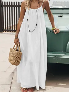 Close-up of white pleated backless maxi beach dress with spaghetti straps